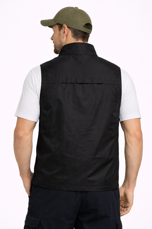 https://cdn.shopify.com/s/files/1/0821/1087/3856/files/Man_wearing_a_black_vest_white_shirt_and_green_cap_on_a_white_background.png?v=1774106093